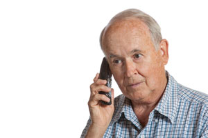 Elderly man speaking to a canadian pharmacy over the phone