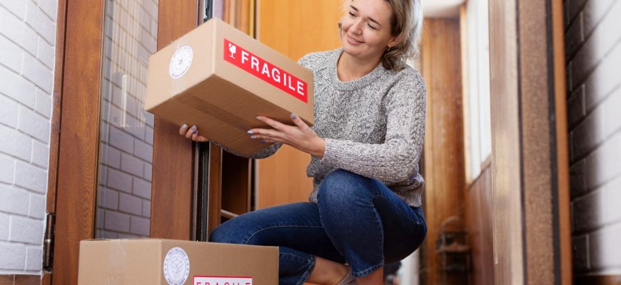Woman receiving a home delivery package from a Canadian pharmacy, representing safe and reliable access to Eliquis from Canada